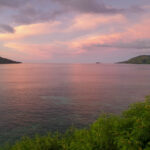 Pale pink and blue sunset over water