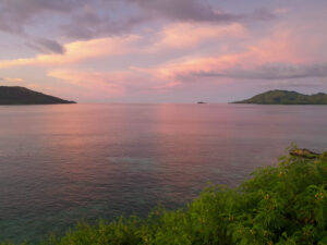 Pale pink and blue sunset over water