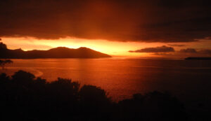 Cloudy orange sunset reflected in the sea