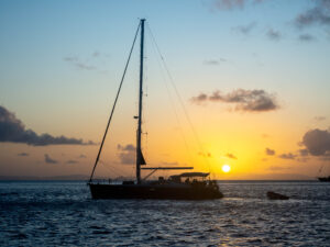 Yacht at anchor against a sunset backdrop