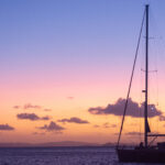 Stationery sailboat at sunset