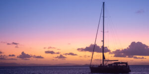 Stationery sailboat at sunset