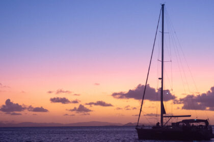 Stationery sailboat at sunset