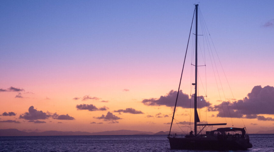 Stationery sailboat at sunset